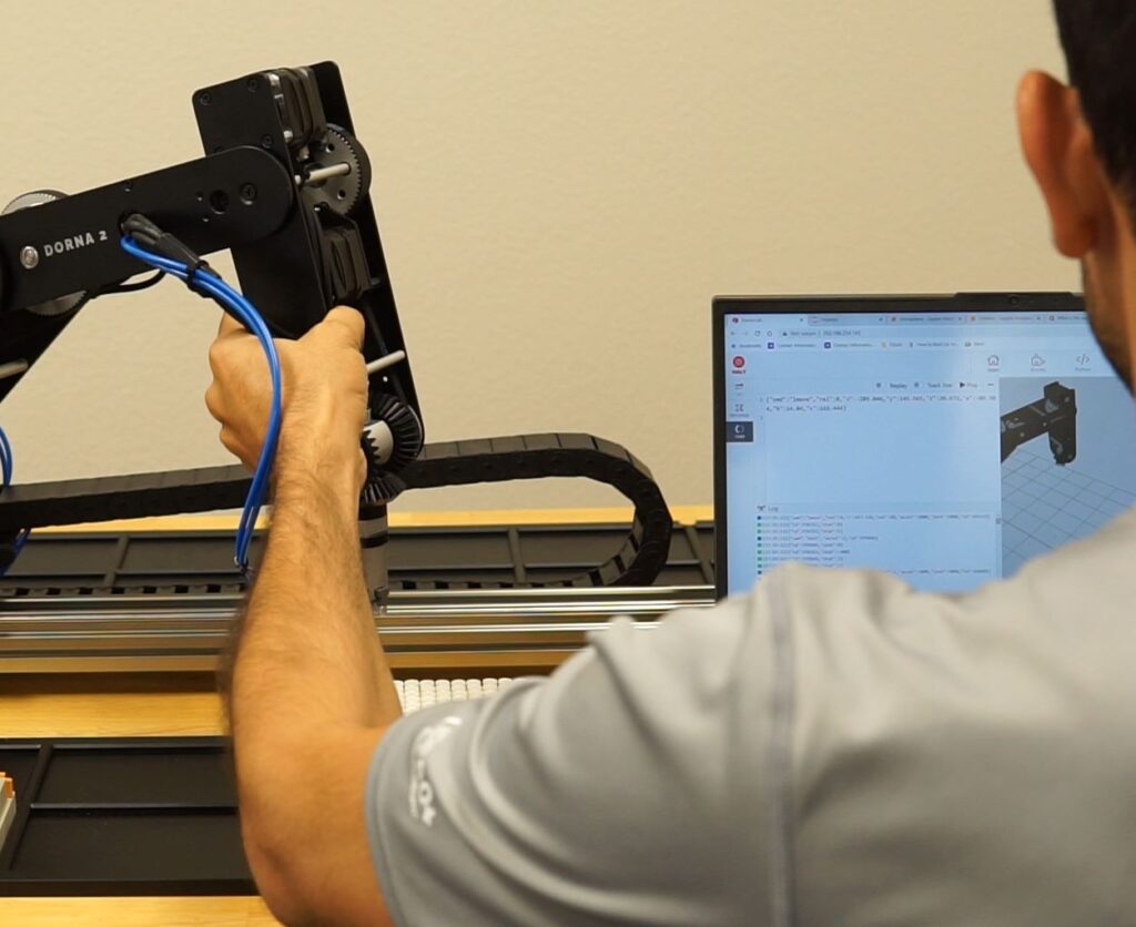 Dorna Robotic Arm being hand trained for its functioning.
